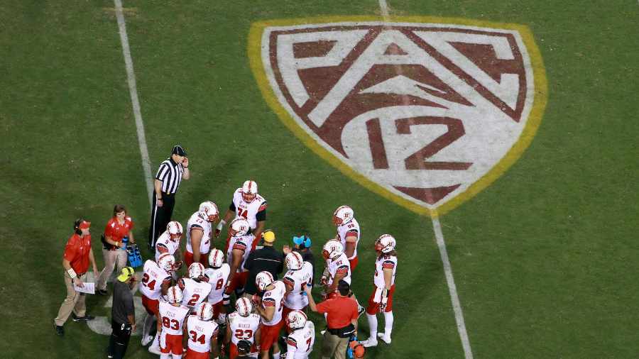 Utah-football-gathers-around-Pac-12-logo-during-football-game...