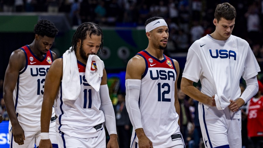 Walker Kessler and members of Team USA leave the court after losing the FIBA Basketball World Cup S...