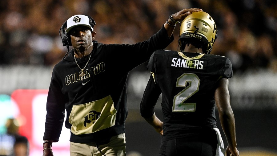 Head coach Deion Sanders of the Colorado Buffaloes celebrates with quarterback Shedeur Sanders #2 after a fourth quarter touchdown against the Colorado State Rams