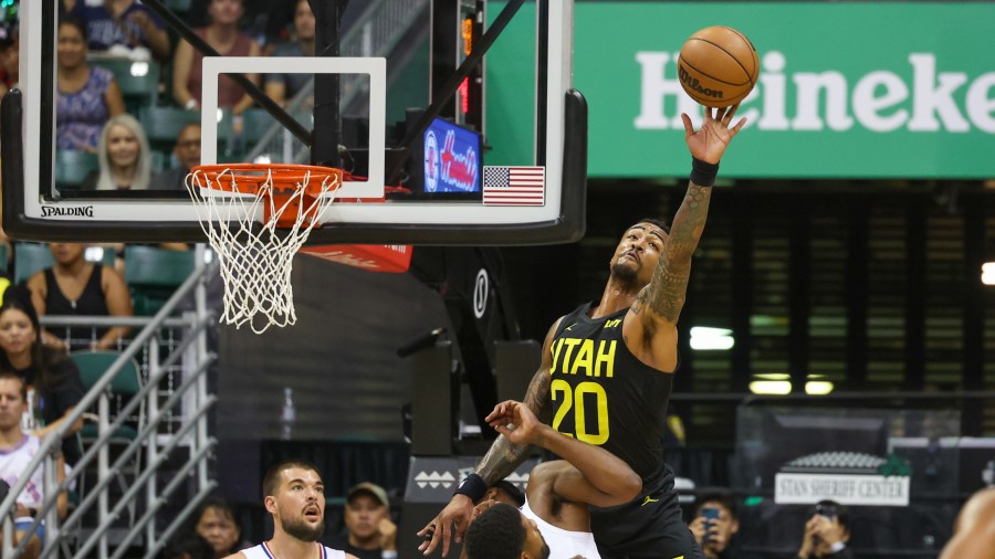 John Collins #20 of the Utah Jazz tips out a rebound during the first half of the preseason game ag...
