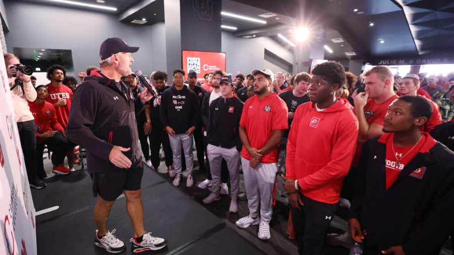 Kyle-Whittingham-talks-to-players-after-crimson-collective-truck-reveal-for-nil-2023...