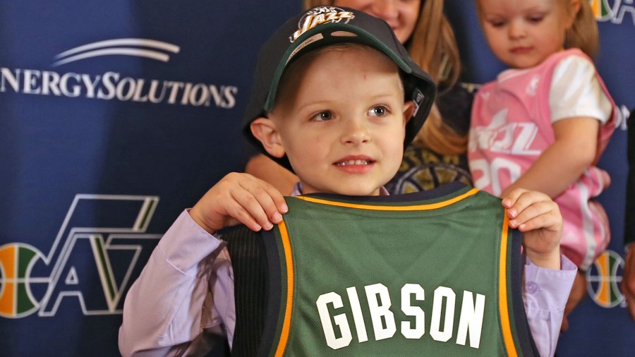 Then five-year-old free agent guard JP Gibson shows off his uniform after signing a one-day contrac...