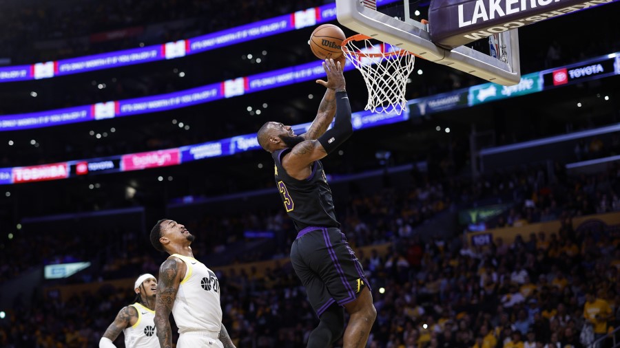 LeBron James #6 of the Los Angeles Lakers scores a basket on layup against John Collins #20 of the ...