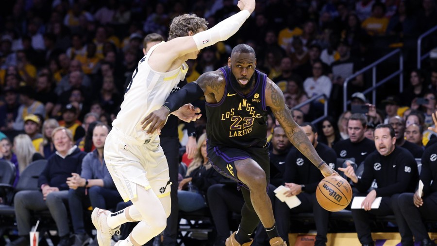 LeBron James #6 of the Los Angeles Lakers drives to the basket against Lauri Markkanen #23 of the U...