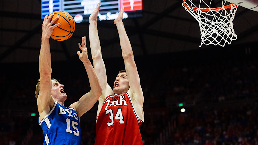 Brigham Young Cougars guard Richie Saunders (15) shoots the ball over Utah Utes center Lawson Lovering (34) during a men's basketball game at the Jon M. Huntsman Center in Salt Lake City on Saturday, Dec. 9, 2023.