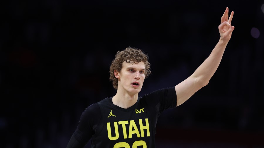 Utah Jazz forward Lauri Markkanen holds up his hand after a three-point shot...