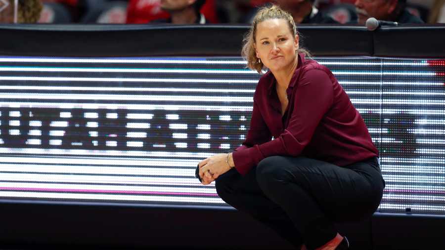 lynne-roberts-watches-a-play-on-the-sidelines-during-a-utah-wbb-game...