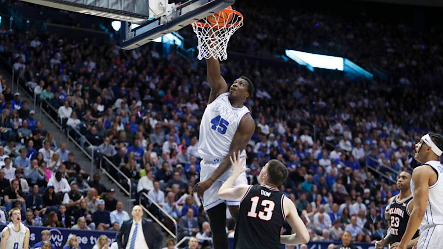 Fousseyni Traore #45 of the Brigham Young Cougars slam dunks the ball over Connor Dow #13 of the Ok...