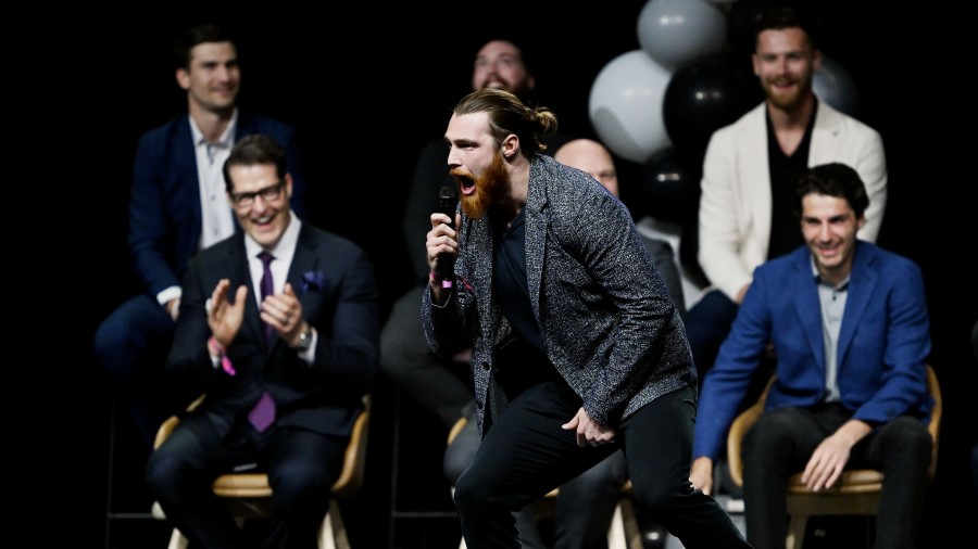 Utah hockey forward Liam O'Brien enthusiastically yells into the mic as he introduces himself as th...