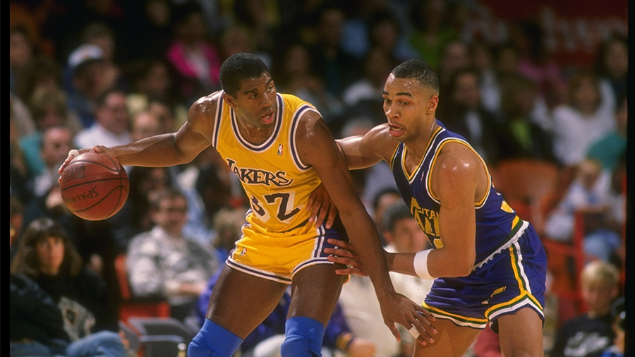 Magic Johnson handles ball in game against Utah Jazz...