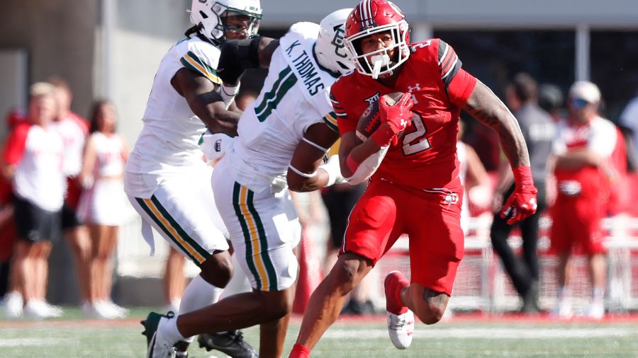 SALT LAKE CITY, UT - SEPTEMBER 7: Micah Bernard #2 of the Utah Utes rushes the ball away from Keato...