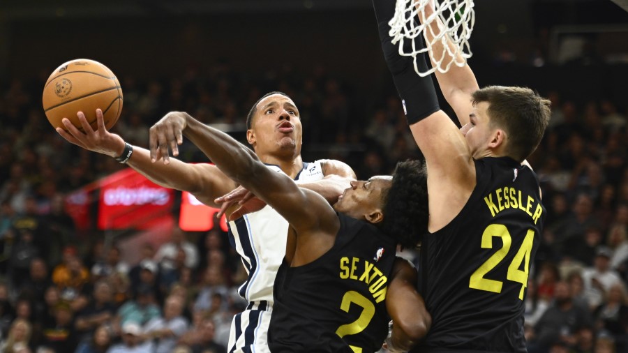 Desmond Bane #22 of the Memphis Grizzlies drives to the basket against Collin Sexton #2 and Walker ...